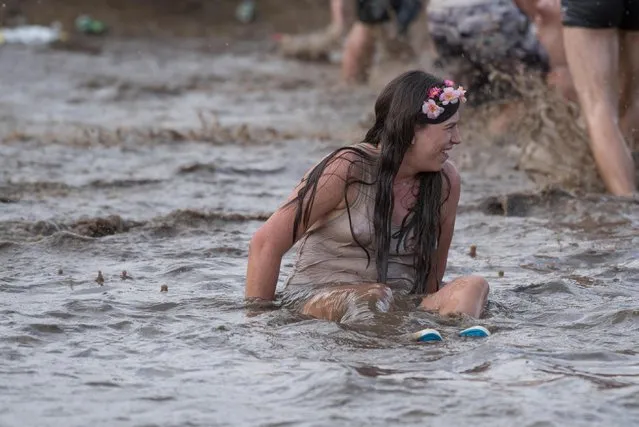 Fans bath in the mud during the “Woodstock Festival Poland” on August 3, 2017 in Kostrzyn Nad Odra, Poland. (Photo by Music/Alamy Stock Photo)