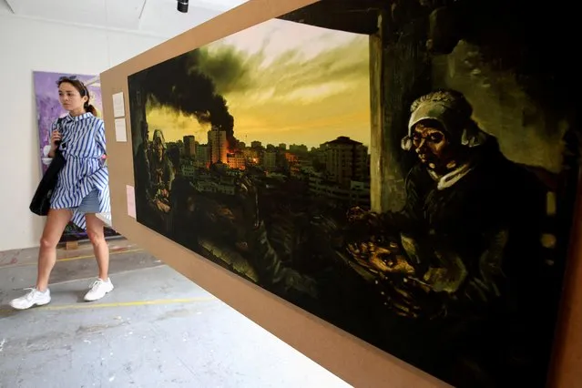 A woman walks past an artwork, part of “Guernica Gaza, 2010-2013” project by Mohammed Al Hawajri exhibited during the “Documenta Fifteen” art fair in Kassel, Germany, June 18, 2022. (Photo by Wolfgang Rattay/Reuters)