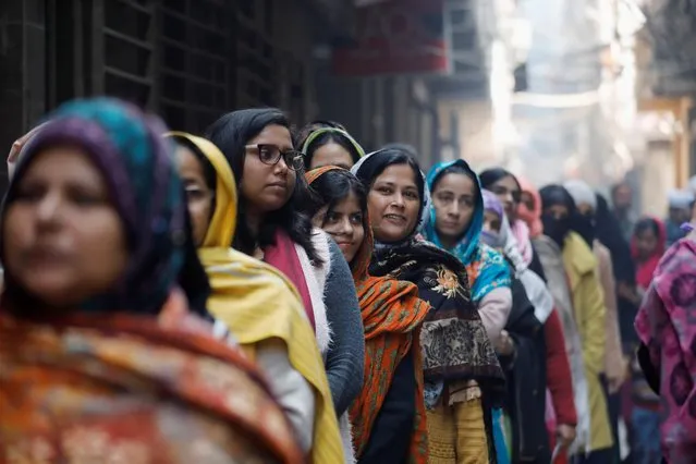 Voters stand in a queue as they wait to cast their vote outside a polling booth during the state assembly election, in Shaheen Bagh, New Delhi, India, February 8, 2020. (Photo by Anushree Fadnavis/Reuters)