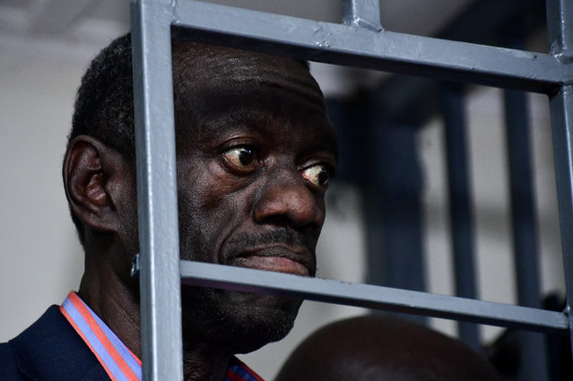 Ugandan four-time presidential aspirant Kizza Besigye stands in the steel dock at the Uganda Military General Court Martial that sits in Makindye suburb of Kampala, Uganda on November 20, 2024. (Photo by Abubaker Lubowa/Reuters)
