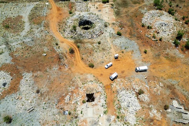 This aerial view shows an open mine shaft where artisanal miners get access to the mine in Stilfontein on November 17, 2024. Hundreds of clandestine miners at a disused South African shaft are struggling to survive in grim conditions because of a police operation to force them out, one of the men who escaped told AFP on November 17, 2024. (Photo by AFP Photo/Stringer)