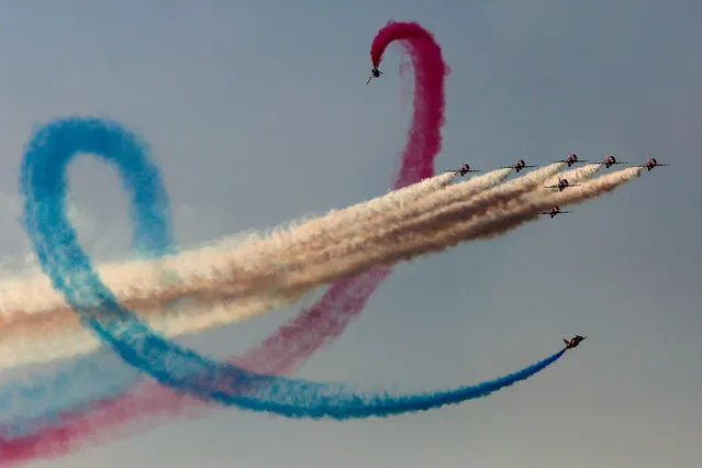 The “Red Arrows” aerobatic team from Britain performs during Athens Flying Week at Tanagra air base, north of Athens, on September 17, 2017. The performance is part of an annual airshow, known as Athens Flying Week, which hosts aerobatic teams from several countries. (Photo by Angelos Tzortzinis/AFP Photo)