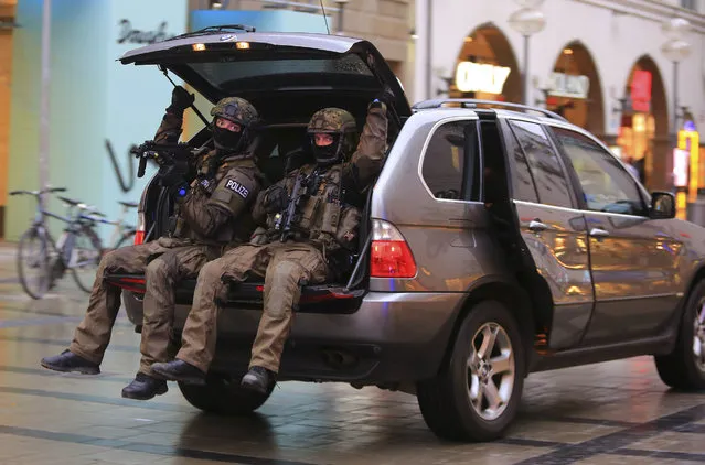 In this Friday, July 22, 2016 photo provided by Wael Ladki heavily armed police officers sit in the trunk of the SUV as they are on the hunt for possible fugitives after a shooting in a shopping mall in Munich, southern Germany. (Photo by Wael Ladki via AP Photo)