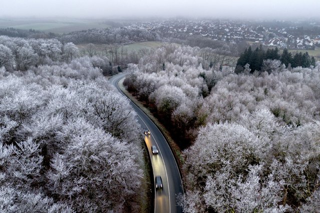 Cars drive through a forest with frozen trees in the Taunus region near Frankfurt, Germany, Monday, December 30, 2024. (Photo by Michael Probst/AP Photo)