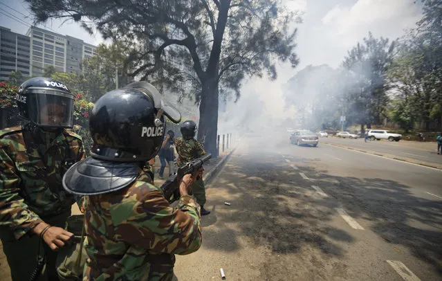 Kenyan police fire tear gas grenades at protesters trying to hold a demonstration against police killings of protesters and opposition supporters, in downtown Nairobi, Kenya Thursday, October 19, 2017. Police fired tear gas grenades and rifles in the air to disperse around 20 activists as they were still gathering in Uhuru Park, despite a court order Tuesday that removed the government's ban on demonstrations. (Photo by Ben Curtis/AP Photo)