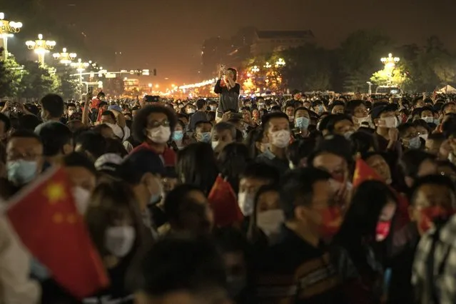 Members of the public attend the flag raising ceremony in Tiananmen Square during National Day in Beijing, China, on Saturday, October 1, 2022. (Photo by Bloomberg)