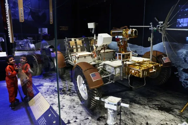 A child looks at a Lunar Roving Vehicle which is similar to the ones that were used in Apollo 15, 16, and 17 missions at the “Destination Moon” gallery at The Smithsonian National Air and Space Museum on its reopening on October 14, 2022 in Washington, DC. (Photo by Alex Wong/Getty Images)