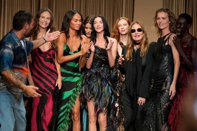 Models Joan Smalls, Isabeli Fontana, Natasha Poly, Maria Carla Boscono, Alex Wek, Karen Elson and Eva Herzigova wear a creations as part of the Roberto Cavalli Spring Summer 2025 collection, that was presented in Milan, Italy, Wednesday, September 18, 2024. (Photo by Luca Bruno/AP Photo)
