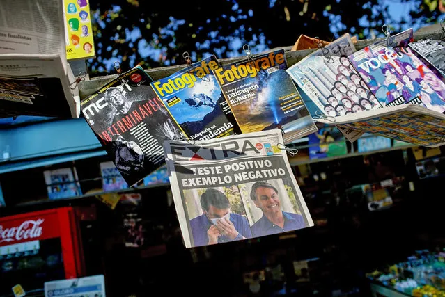 View of the front page of a newspaper with the news of Brazilian President Jair Bolsonaro being a confirmed case of the new coronavirus, at a newsstand in Rio de Janeiro, Brazil on July 08, 2020. (Photo by Mauro Pimentel/AFP Photo)