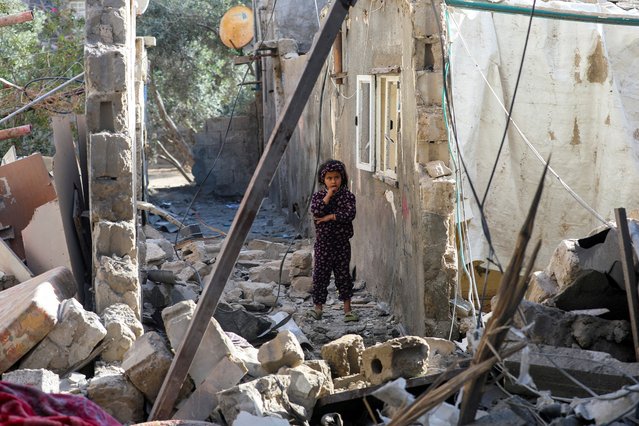 A Palestinian girl inspects the damage at the site of an Israeli strike on a house, in Deir Al-Balah in the central Gaza Strip, on March 25, 2025. (Photo by Ramadan Abed/Reuters)