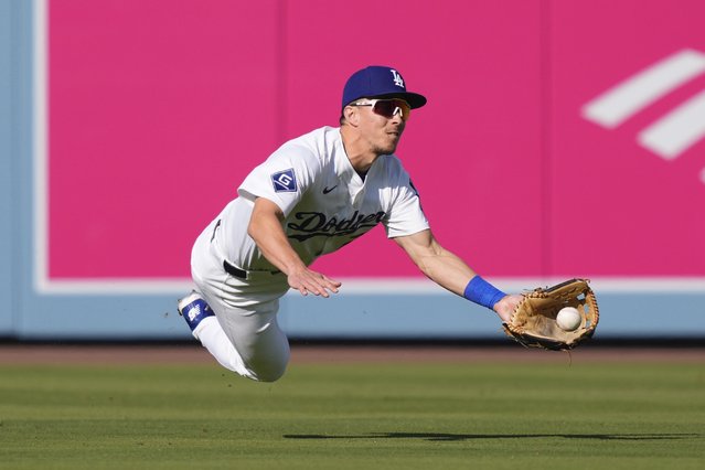 Los Angeles Dodgers center fielder Tommy Edman makes a catch on a ball hit by Chicago Cubs' Ian Happ during the third inning of a baseball game Sunday, April 13, 2025, in Los Angeles. (Photo by Mark J. Terrill/AP Photo)