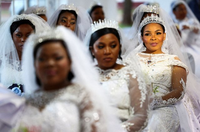 Brides wait to take part in a mass wedding ceremony at the International Pentecostal Holiness Church (IPHC) in Zuurbekom, west of Johannesburg, South Africa, on April 20, 2025. As part of Easter celebrations, over 54 couples, including first-time and polygamous unions, exchanged vows. (Photo by Siphiwe Sibeko/Reuters)