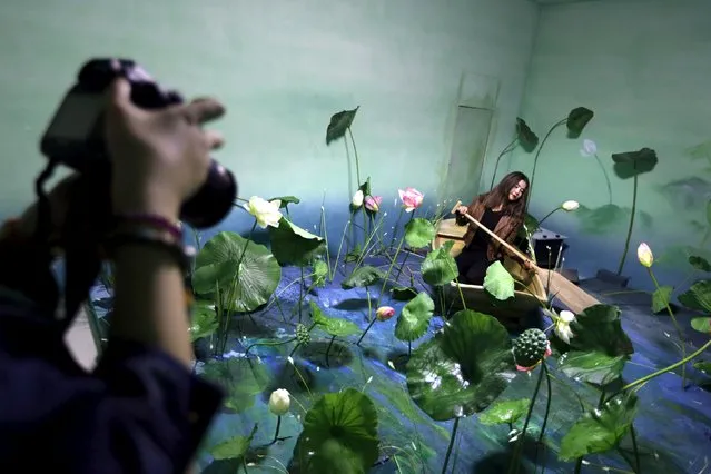A visitor poses for a photograph in an optical illusion installation at the Imagine Your Museum of Art exhibition in Beijing October 2, 2015. (Photo by Jason Lee/Reuters)
