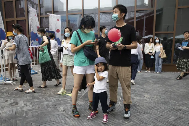Residents visit a weekend open air market in Beijing on Saturday, August 8, 2020. (Photo by Ng Han Guan/AP Photo)