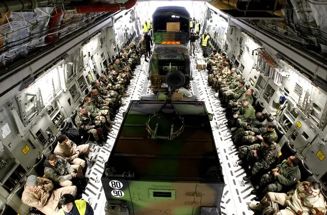 French military personnel and their vehicles are seen aboard a U.S. Air Force transport aircraft before departing for Mali from Istres airbase, near Marseille, France, January 24, 2013. (Photo by Claude Paris/Associated Press)