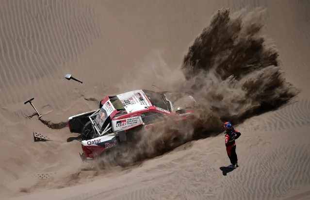 Toyota's driver Nasser Al-Attiyah of Qatar and his co-driver Matthieu Baumel of France get stuck in the sand dunes during Stage 4 of the Dakar 2018, in and around San Juan De Marcona, Peru, on January 9, 2018. (Photo by Franck Fife/AFP Photo)