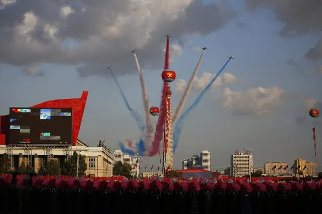 Jets fly over the Juche Tower during a parade on the Kim Il Sung Square, Saturday, October 10, 2015, in Pyongyang, North Korea. (Photo by Wong Maye-E/AP Photo)