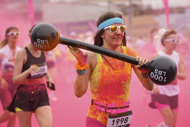 Participants get covered with colored powder during The Color Run in Moscow, Russia, Sunday, June 8, 2025. (Photo by Pavel Bednyakov/AP Photo)