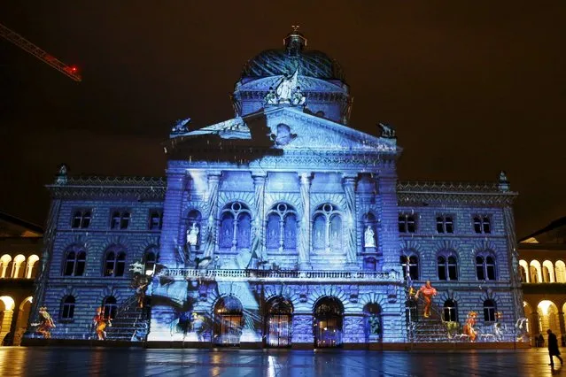 The Swiss Federal Palace (Bundeshaus) is illuminated by giant light projection "The Jewel of the Mountains" in Bern, Switzerland October 15, 2015. (Photo by Ruben Sprich/Reuters)