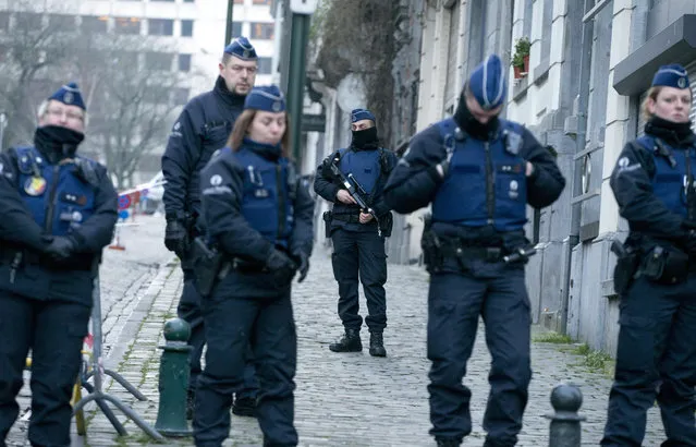 Police guard as they await a convoy carrying Salah Abdeslam and other members of the trial arrives under police guard at the Brussels Justice Palace in Brussels on Monday, February 5, 2018. Salah Abdeslam and Soufiane Ayari face trial for taking part in a shooting incident in Vorst, Belgium on March 15, 2016. The incident took place when six members of a Franco-Belgian research team investigating the attacks in Paris were conducting a search in an allegedly empty safe house of the terrorists and were attacked. (Photo by Virginia Mayo/AP Photo)