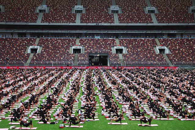 People take part in a mass stretching session during the Moscow Sports Day festival at the Luzhniki Olympic Complex in Moscow, Russia on July 5, 2025. (Photo by Evgenia Novozhenina/Reuters)