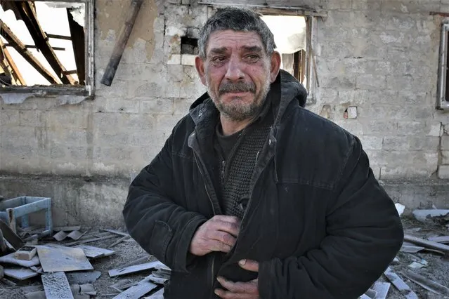 Mayor Ivanov, 75, cries after his wife was killed when a Russian rocket ruined their house in a night rocket attack in Zaporizhzhya, Ukraine, Thursday, January 26, 2023. (Photo by Andriy Andriyenko/AP Photo)