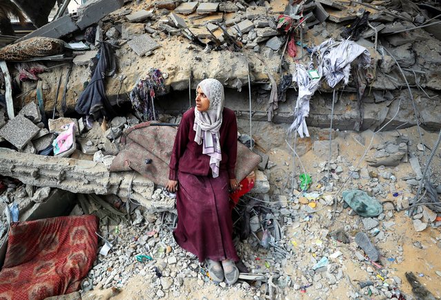 A Palestinian woman sits amidst the damage at an UNRWA school sheltering displaced people that was hit in an Israeli air strike on Sunday, in Gaza City, on June 30, 2025. (Photo by Mahmoud Issa/Reuters)