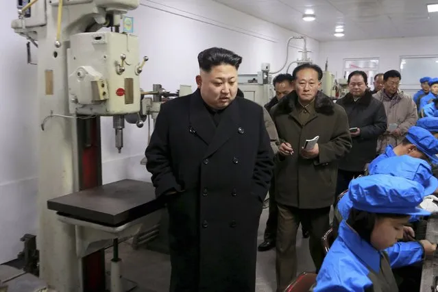 North Korean leader Kim Jong Un (L) visits the Kangdong Precision Machine Plant in this undated photo released by North Korea's Korean Central News Agency (KCNA) in Pyongyang January 16, 2015. (Photo by Reuters/KCNA)