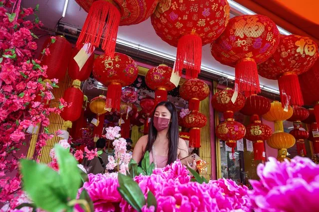 A woman shops for Lunar New Year decorations at Petaling Street, Chinatown on January 15, 2023 in Kuala Lumpur, Malaysia. (Photo by Annice Lyn/Getty Images)