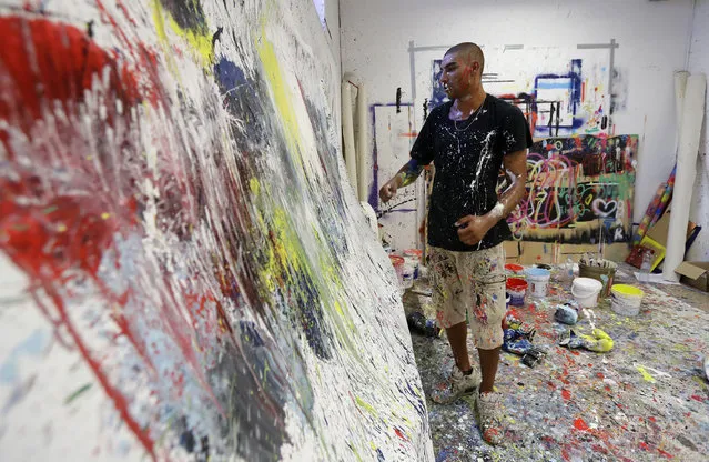 In this photo taken on Tuesday, September 6, 2016 Omar Hassan looks at his creation in his studio in Milan, Italy. (Photo by Antonio Calanni/AP Photo)