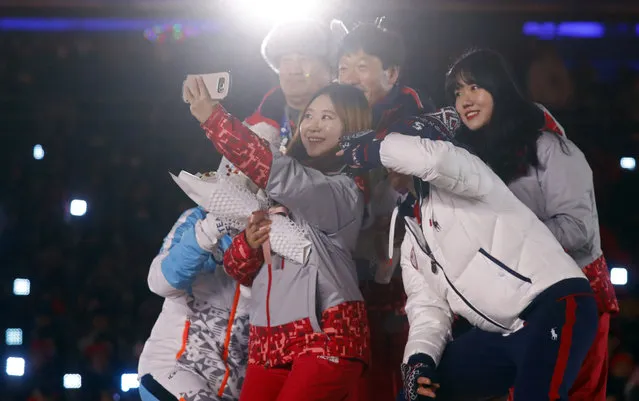 Representatives of the Olympic volunteers take a selfie with athletes Kikkan Randell of the U.S. and Emma Terho of Finland during the closing ceremony of the PyeongChang Winter Olympic Games at the Olympic Stadium in Pyeongchang, South Korea, on February 25, 2018. (Photo by Kai Pfaffenbach/Reuters)