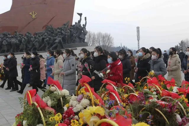 North Koreans visit and pay respect to the statues of late leaders Kim Il Sung and Kim Jong Il on Mansu Hill in Pyongyang, North Korea Sunday, January 22, 2023 on the occasion of the Lunar New Year. (Photo by Jon Chol Jin/AP Photo)