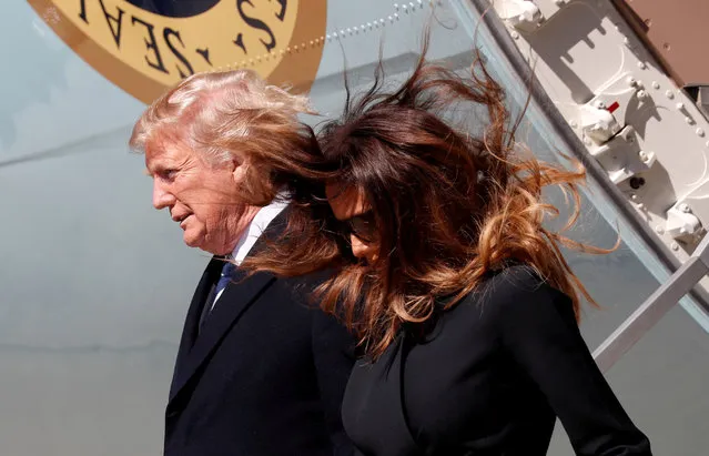 Into high winds, U.S. President Donald Trump and first lady Melania Trump step from Air Force One to attend the funeral of Rev. Billy Graham in Charlotte, North Carolina, U.S. March 2, 2018. (Photo by Kevin Lamarque/Reuters)