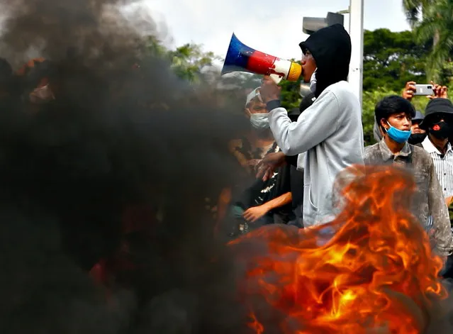 University students burn tires during a protest against the government’s labor reforms bill in Jakarta, Indonesia, October 28, 2020. (Photo by Ajeng Dinar Ulfiana/Reuters)