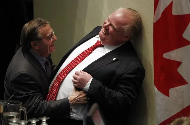 Toronto's Chief Budget Officer Councillor Frank Di Giorgio (L) shares a moment with Toronto Mayor Rob Ford during a budget meeting at City Hall in Toronto, in this January 30, 2014 file photo. (Photo by Aaron Harris/Reuters)