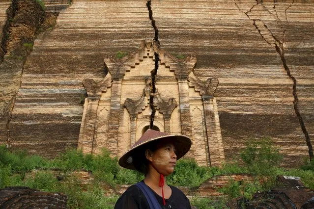 Handicraft vendor Zar Zar, 28, poses as she waits for tourists in front of the ruins of the temple Pahtodawgyi in Mingu, Myanmar, October 7, 2015. (Photo by Jorge Silva/Reuters)