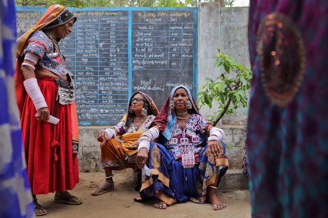 Tribal women sit as they wait to cast their votes at a polling station during the fourth phase of India's general election in Rangareddy district in the southern state of Telangana, India, on May 13, 2024. (Photo by Almaas Masood/Reuters)