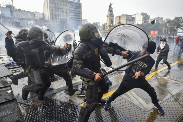 Anti-government protesters clash with police outside Congress, as lawmakers debate a reform bill promoted by Argentine President Javier Milei in Buenos Aires, Argentina, Wednesday, June 12, 2024. (Photo by Gustavo Garello/AP Photo)