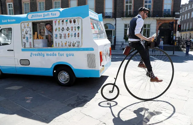 A participant in the Tweed Run cycle ride pulls away from an ice cream van in London, Britain May 5, 2018. (Photo by Peter Nicholls/Reuters)