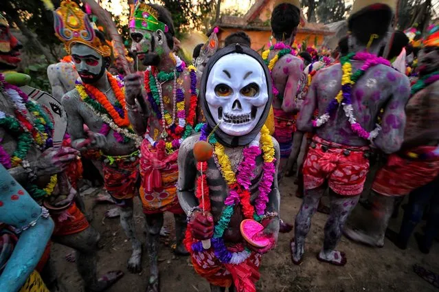 Hindu devotees with their faces and bodies painted with different colors wear masks as they take part during the annual Gajan Festival in Bardhhaman, India on April 12, 2023. (Photo by Avishek Das/SOPA Images/Rex Features/Shutterstock)
