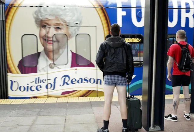 A man in his underwear waits to board an arriving light rail train during the annual No Pants Light Rail Ride organized by the Emerald City Improv group in Seattle, Washington January 11, 2015. (Photo by Jason Redmond/Reuters)