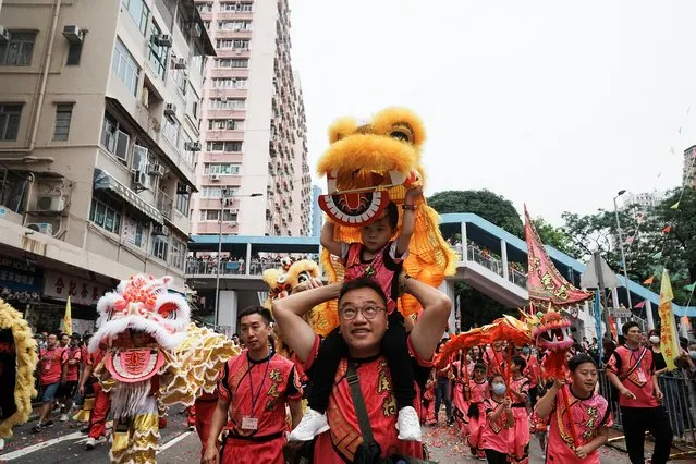 A young participant preforms lion dance during a parade celebrating Tin Hau festival at Yuen Long district, in Hong Kong, China on May 12, 2023. (Photo by Lam Yik/Reuters)