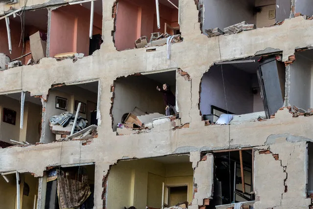 A woman reacts in her damaged apartment on the explosion site on November 4, 2016 after a strong blast in the southeastern Turkish city of Diyarbakir. At least one person was killed and 30 injured in a blast outside a police building on November 4 in Diyarbakir, the centre of the Kurdish minority, medical sources told AFP. The explosion occurred just hours after police detained the two co-leaders of the country's main pro-Kurdish party and several other MPs in a major escalation of a broader crackdown against leading Kurds. (Photo by Ilyas Akengin/AFP Photo)