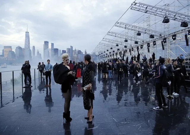 Patrons arrive for Saint Laurent Spring 2019 menswear fashion show Wednesday, June 6, 2018, in Liberty Island, N.Y. (Photo by Frank Franklin II/AP Photo)