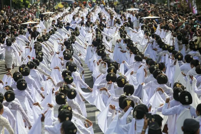 Women wearing white costumes perform Bedhayan Naradipta traditional dance in a festival held to commemorate the International Dance Day, in Solo, Central Java, Indonesia on April 29, 2023. More than 700 women take part in the mass dance performance. (Photo by Agoes Rudianto/Anadolu Agency via Getty Images)