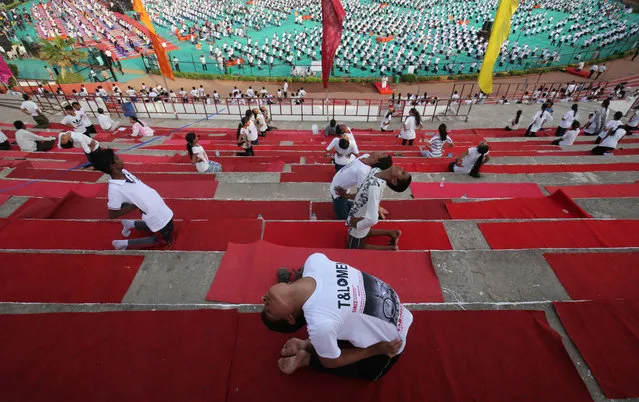 Participants perform yoga at a stadium during International Yoga Day in Ahmedabad, India, June 21, 2018. (Photo by Amit Dave/Reuters)