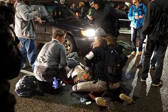 A demonstrator is treated for a gunshot wound during a protest against the election of Republican Donald Trump as President of the United States in Portland, Oregon, U.S. November 12, 2016. (Photo by Cole Howard/Reuters)