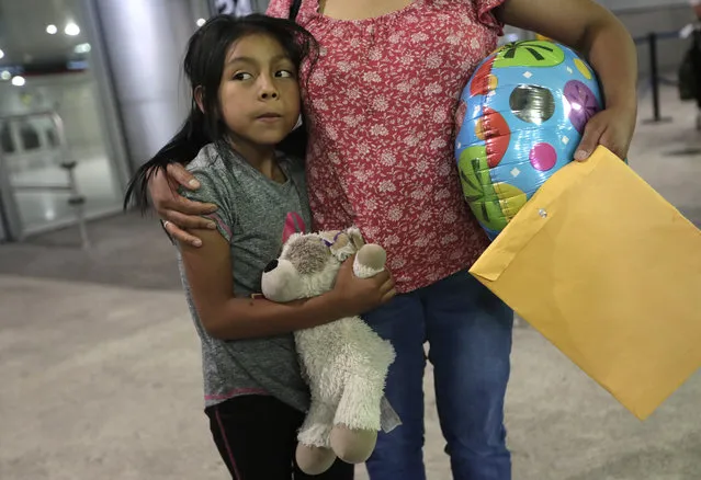 Buena Ventura Martin-Godinez, right, stands with her daughter Janne after being reunited at Miami International Airport, Sunday, July 1, 2018, in Miami. Martin crossed the border into the United States from Mexico in May with her son, fleeing violence in Guatemala. Her husband crossed two weeks later with their 7-year-old daughter Janne. All were caught by the Border Patrol, and were separated. Her daughter was released Sunday from a child welfare agency in Michigan. (Photo by Lynne Sladky/AP Photo)