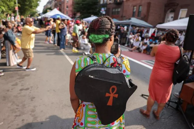 A person wearing an Africa shaped backpack stands during a Juneteenth celebration in Brooklyn, New York, U.S., June 19, 2023. (Photo by Amr Alfiky/Reuters)