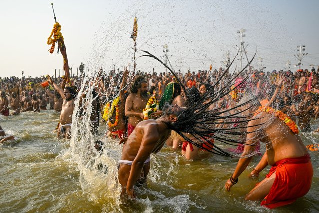 Naga Sadhus or Hindu holy men take a dip in Sangam, the confluence of Ganges, Yamuna and mythical Saraswati rivers, on an auspicious occasion of “Mauni Amavasya” during the Maha Kumbh Mela festival in Prayagraj on January 29, 2025. A pre-dawn stampede at the world's largest religious gathering killed at least 30 people in India on January 29, with many more injured after a surging crowd spilled out of a police cordon and trampled bystanders. (Photo by Arun Sankar/AFP Photo)